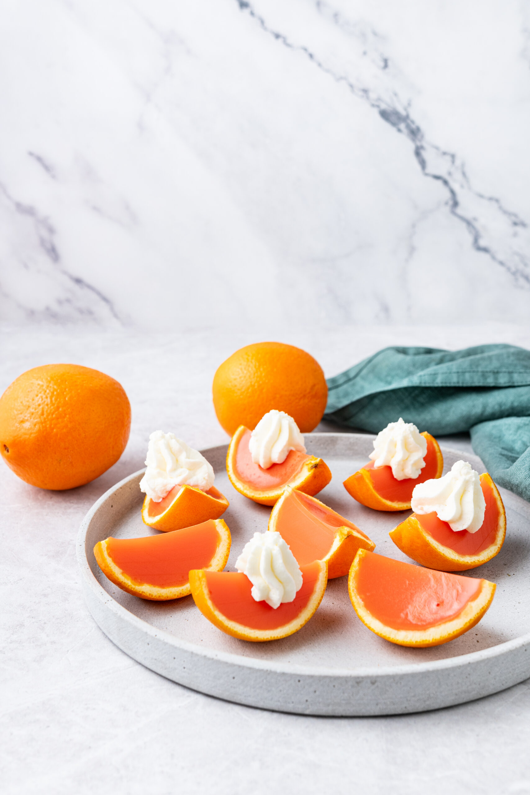 Orange creamsicle Jell-O shots in plate diagonal shot