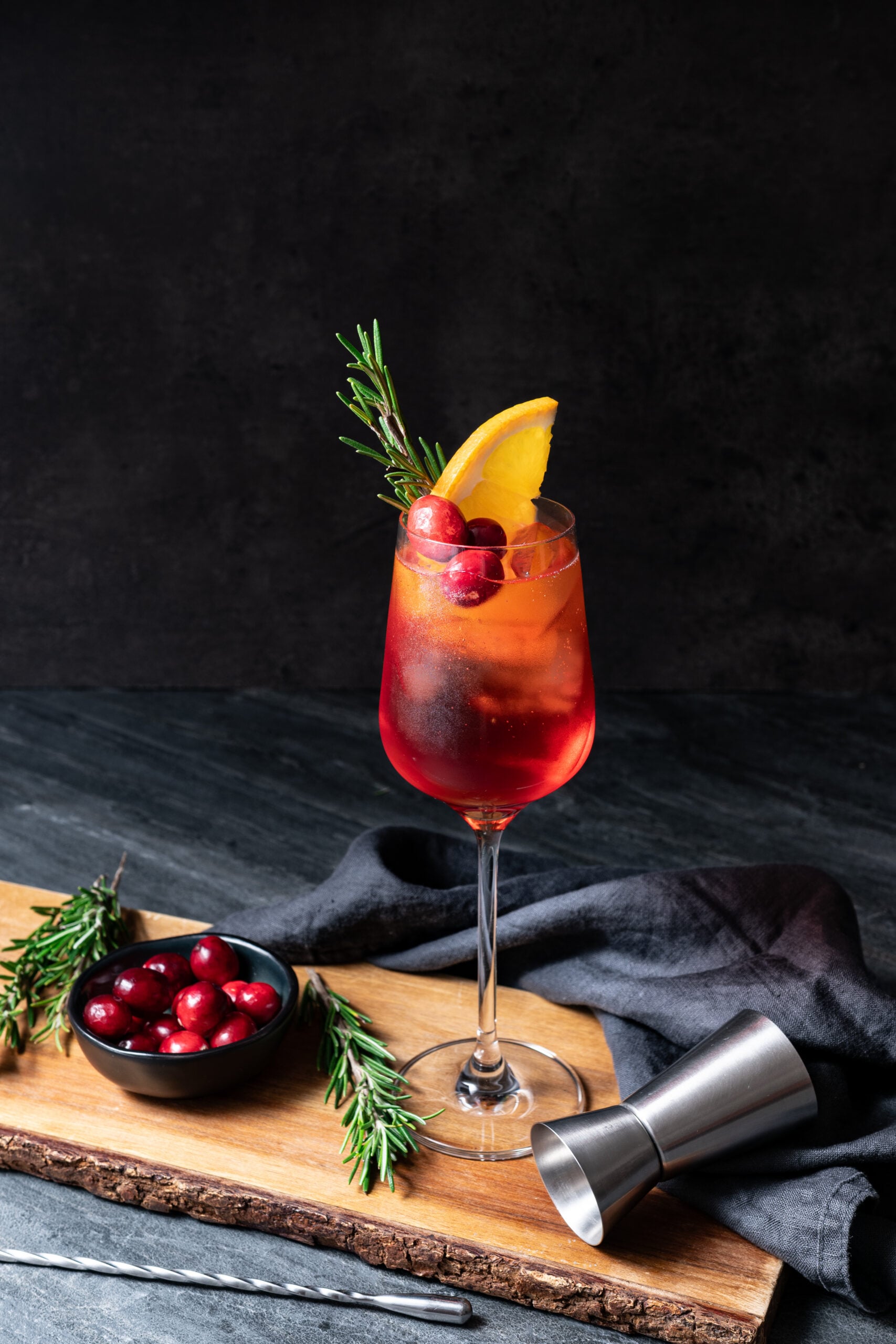 Cranberry Aperol Spritz in a glass shot from the side
