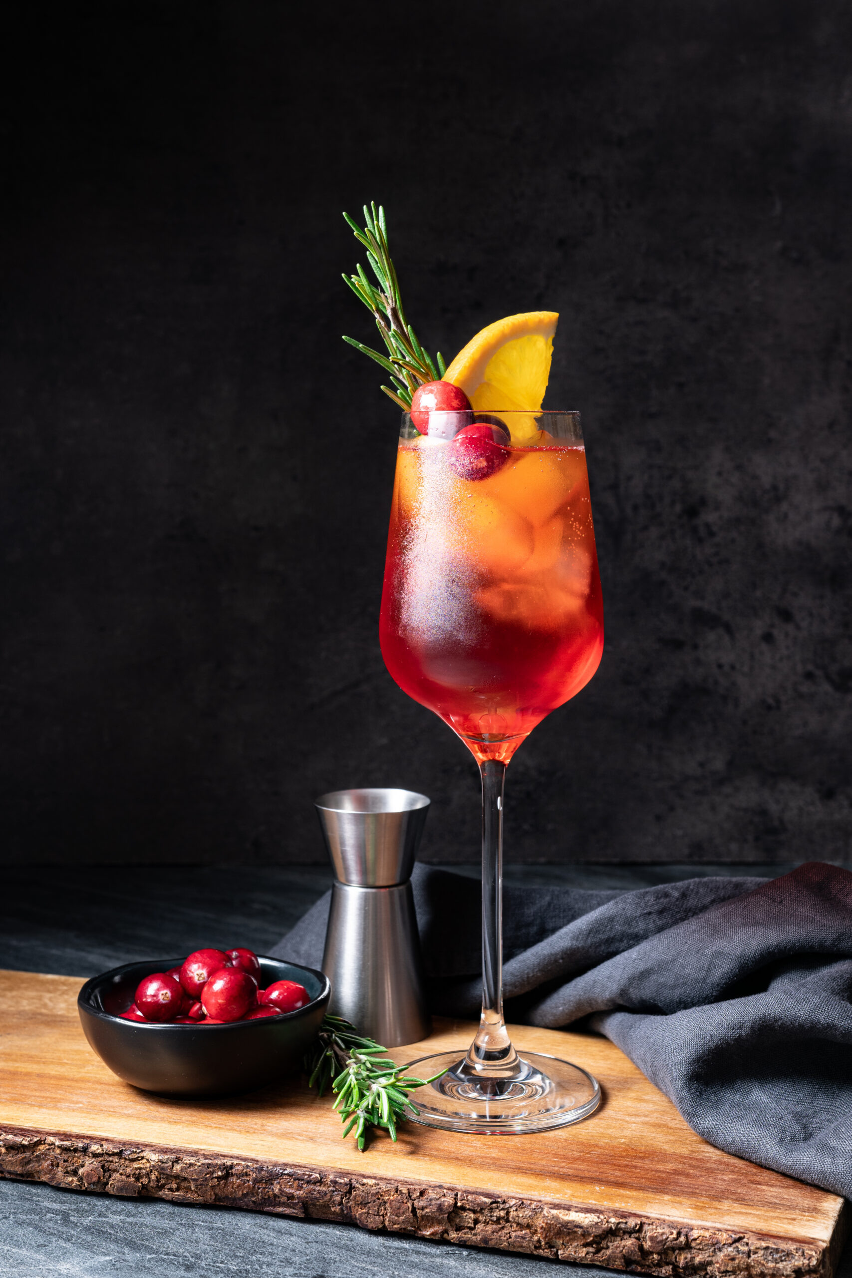 Cranberry Aperol Spritz in a glass shot from the side