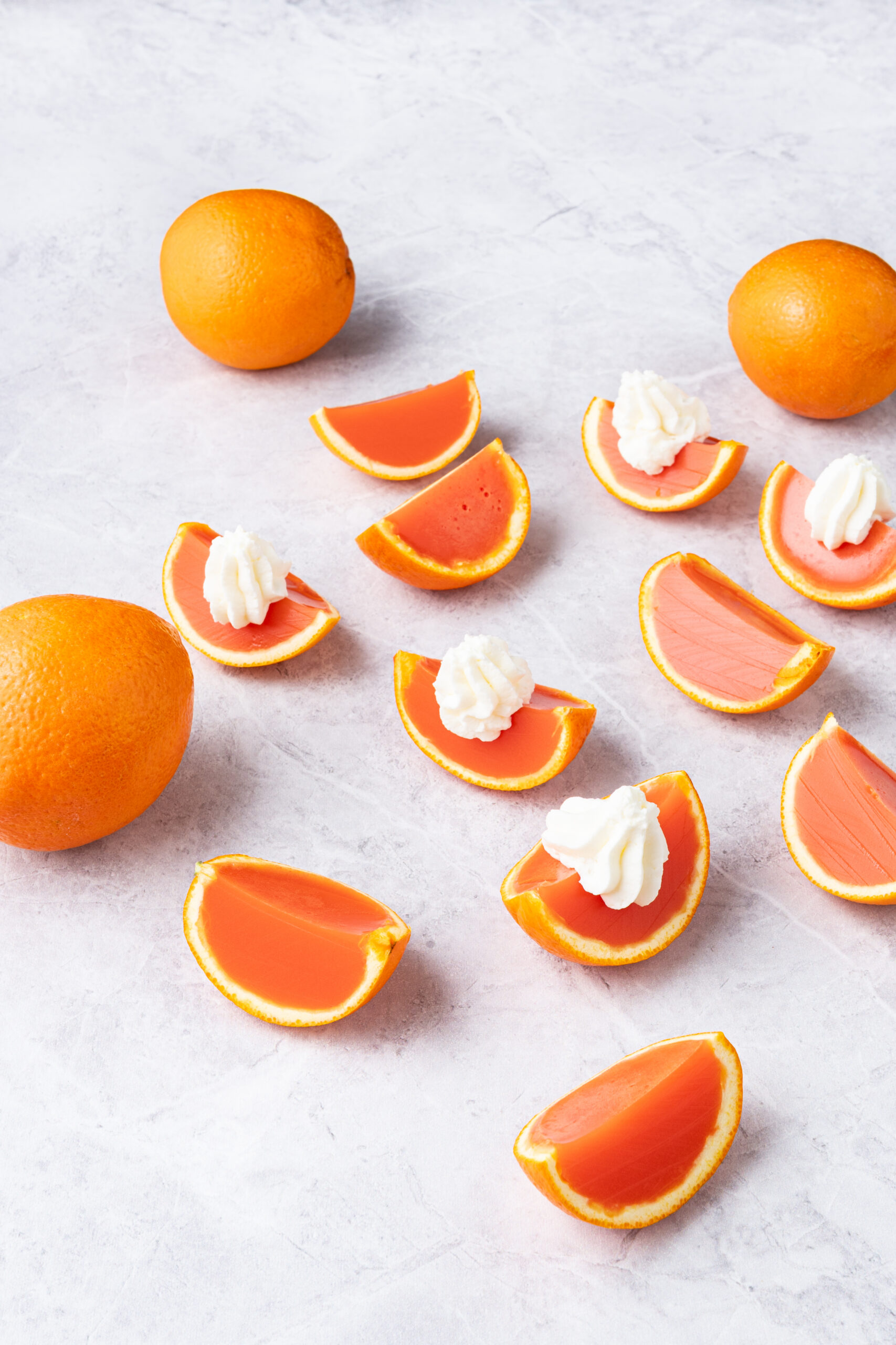 Orange creamsicle Jell-O shots on a table
