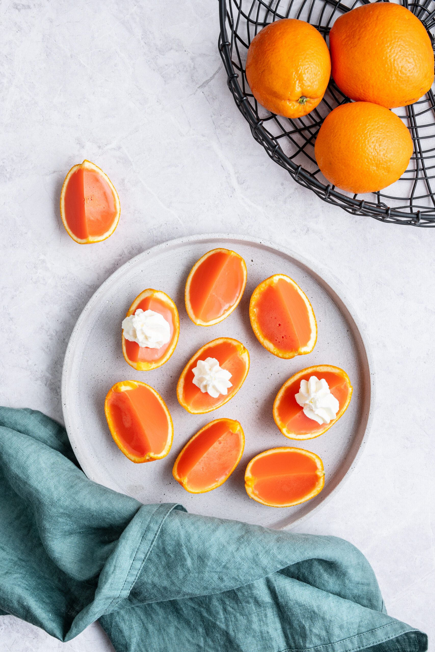 Orange creamsicle Jell-O shots in a plate shot from above