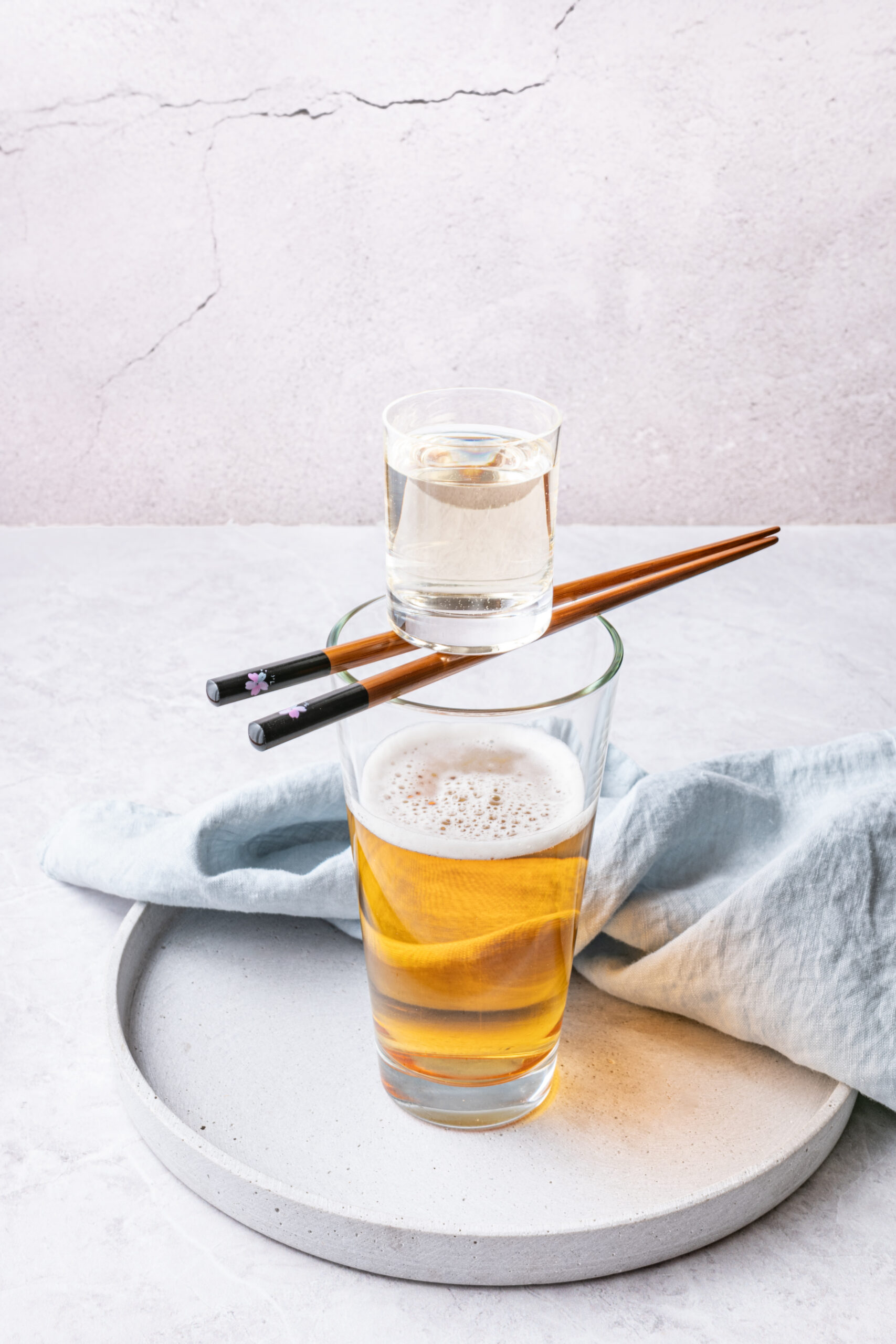 Sake Bomb Recipe - sake shot over a beer glass shot from diagonal