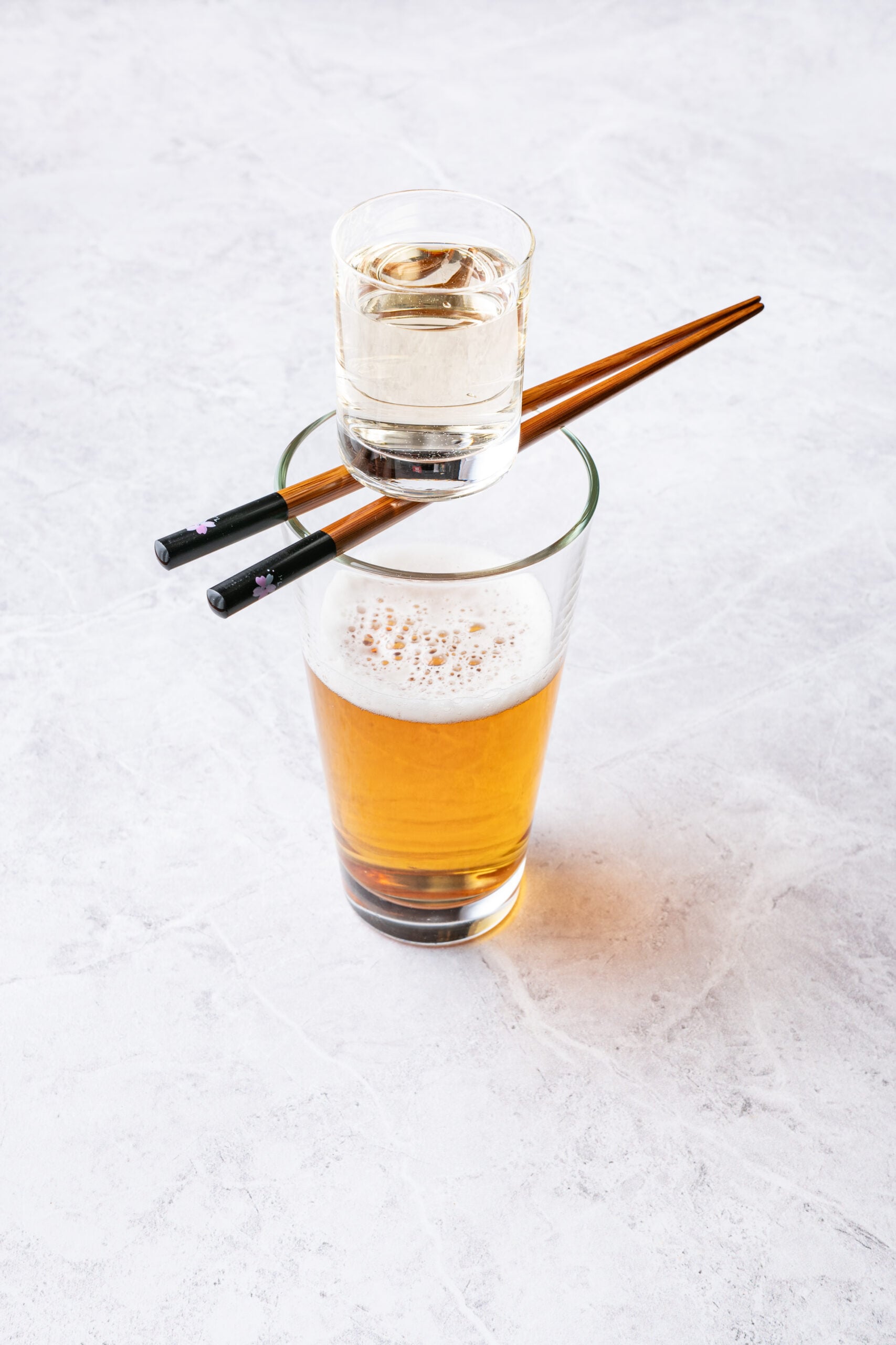 Sake Bomb Recipe - sake shot falling into a beer glass