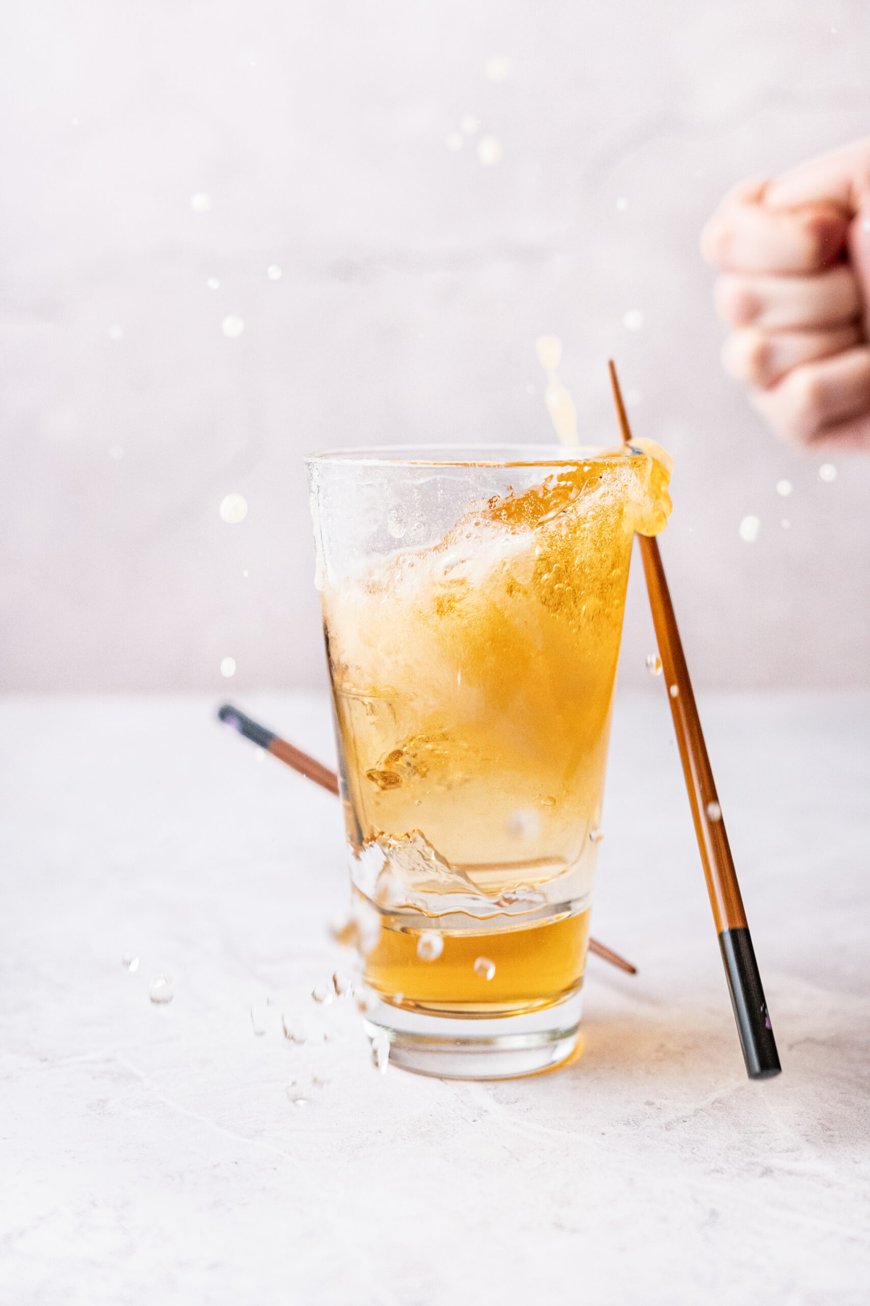 Sake Bomb Recipe - sake shot over a beer glass shot from diagonal