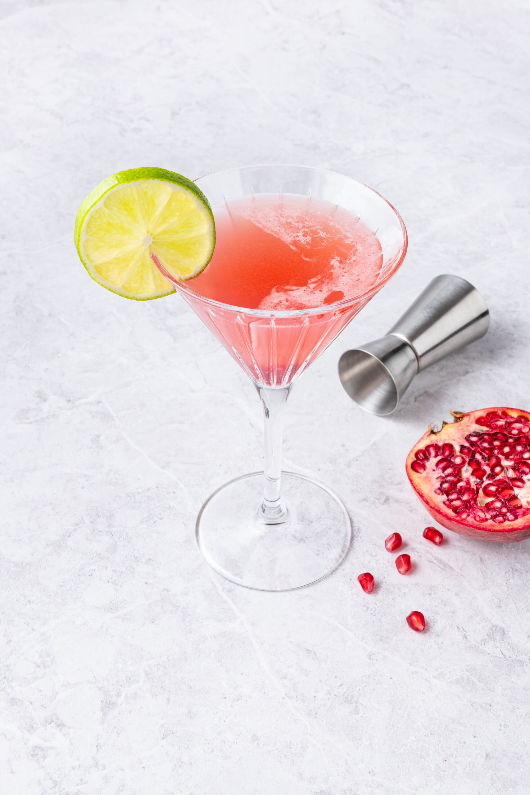 Pomegranate Cosmopolitan in a cocktail glass diagonal shot