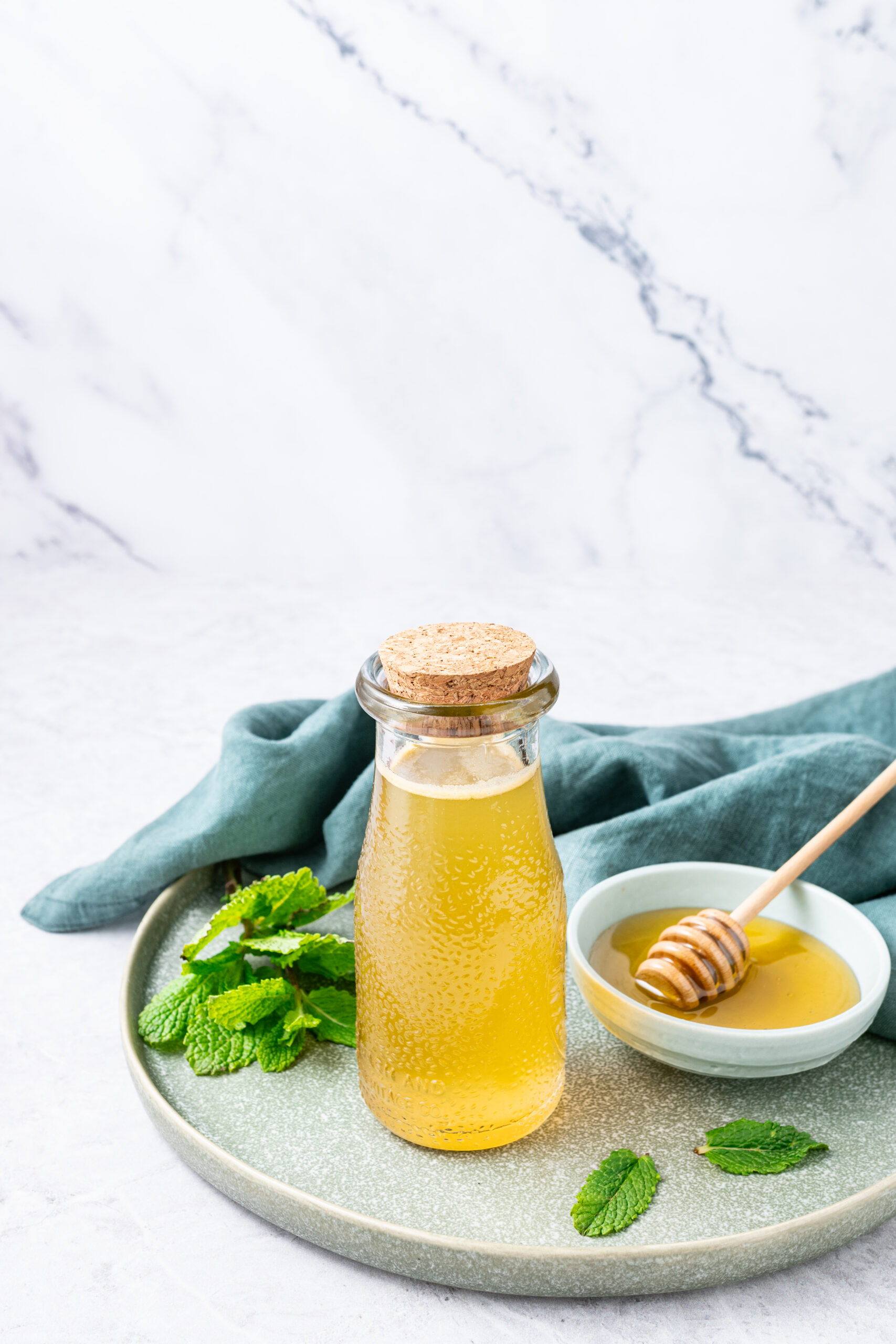 Mint Simple Syrup in a glass bottle diagonal shot