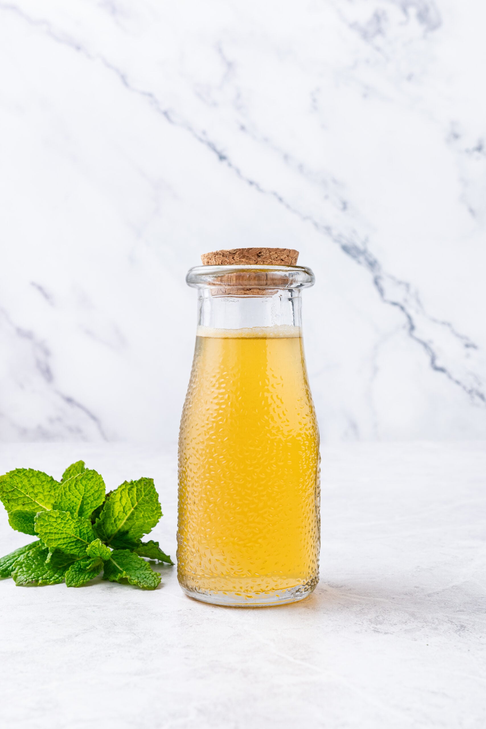 Mint Simple Syrup in a glass bottle close-up shot