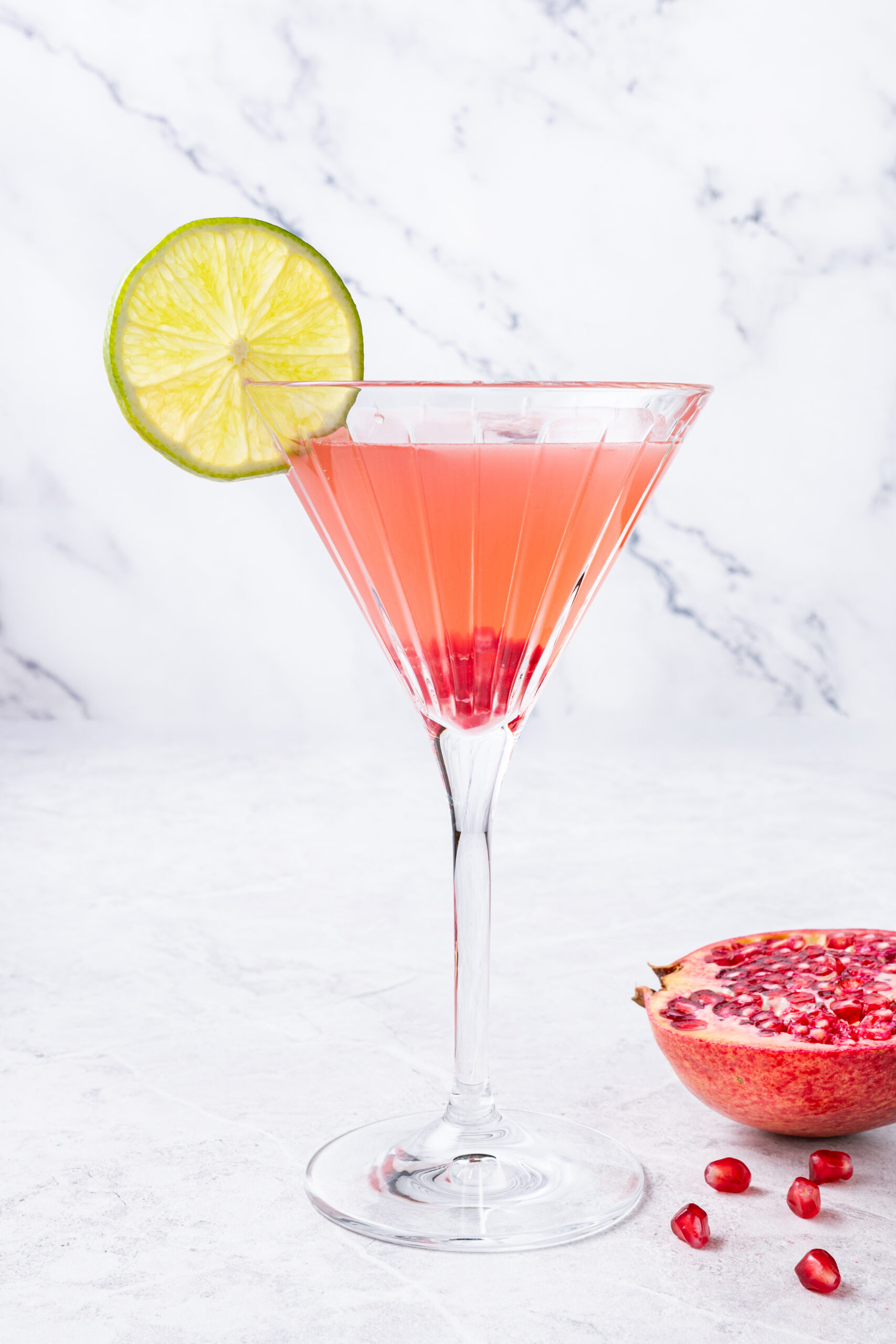 Pomegranate Cosmopolitan in a cocktail glass side shot