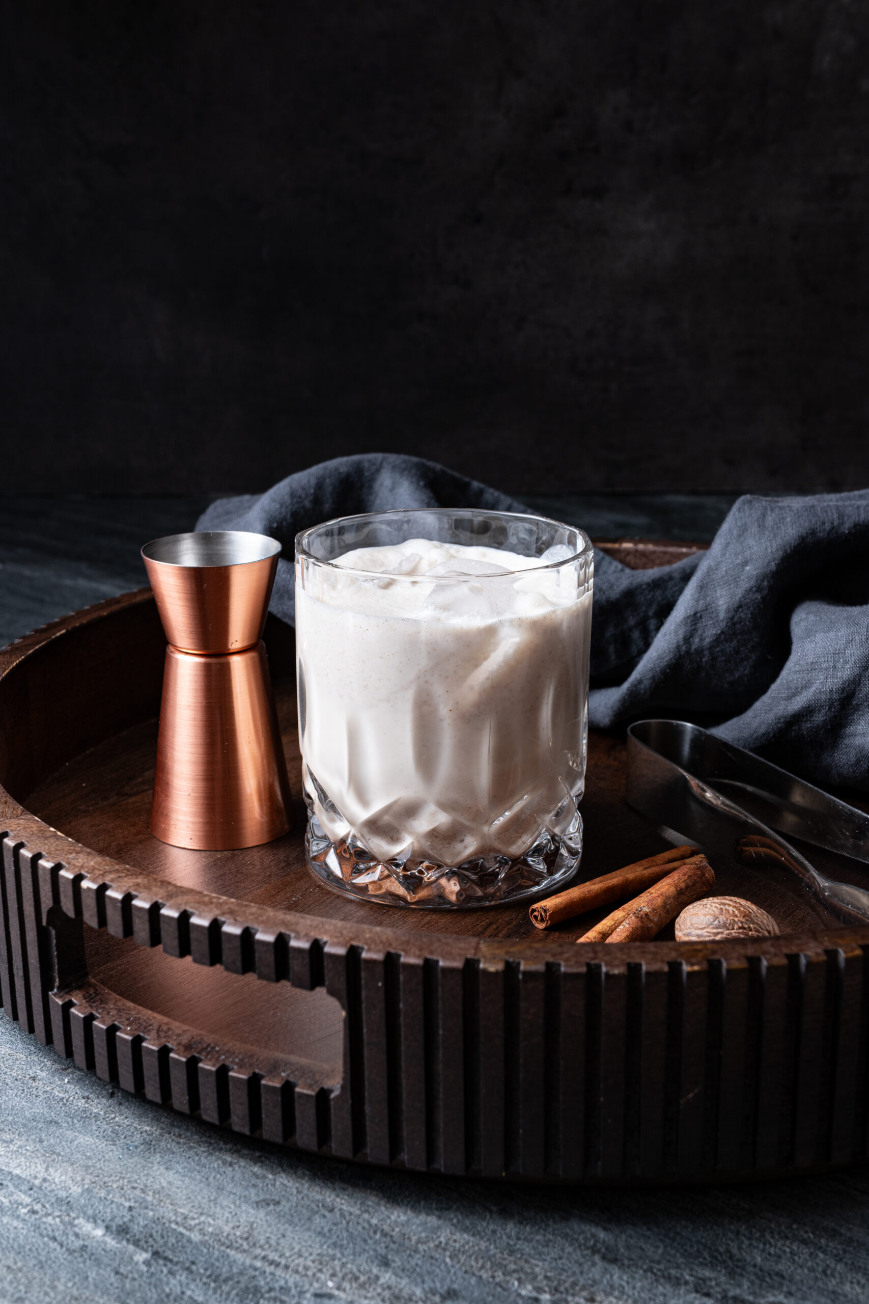 RumChata served in a glass with ice on a tray side shot